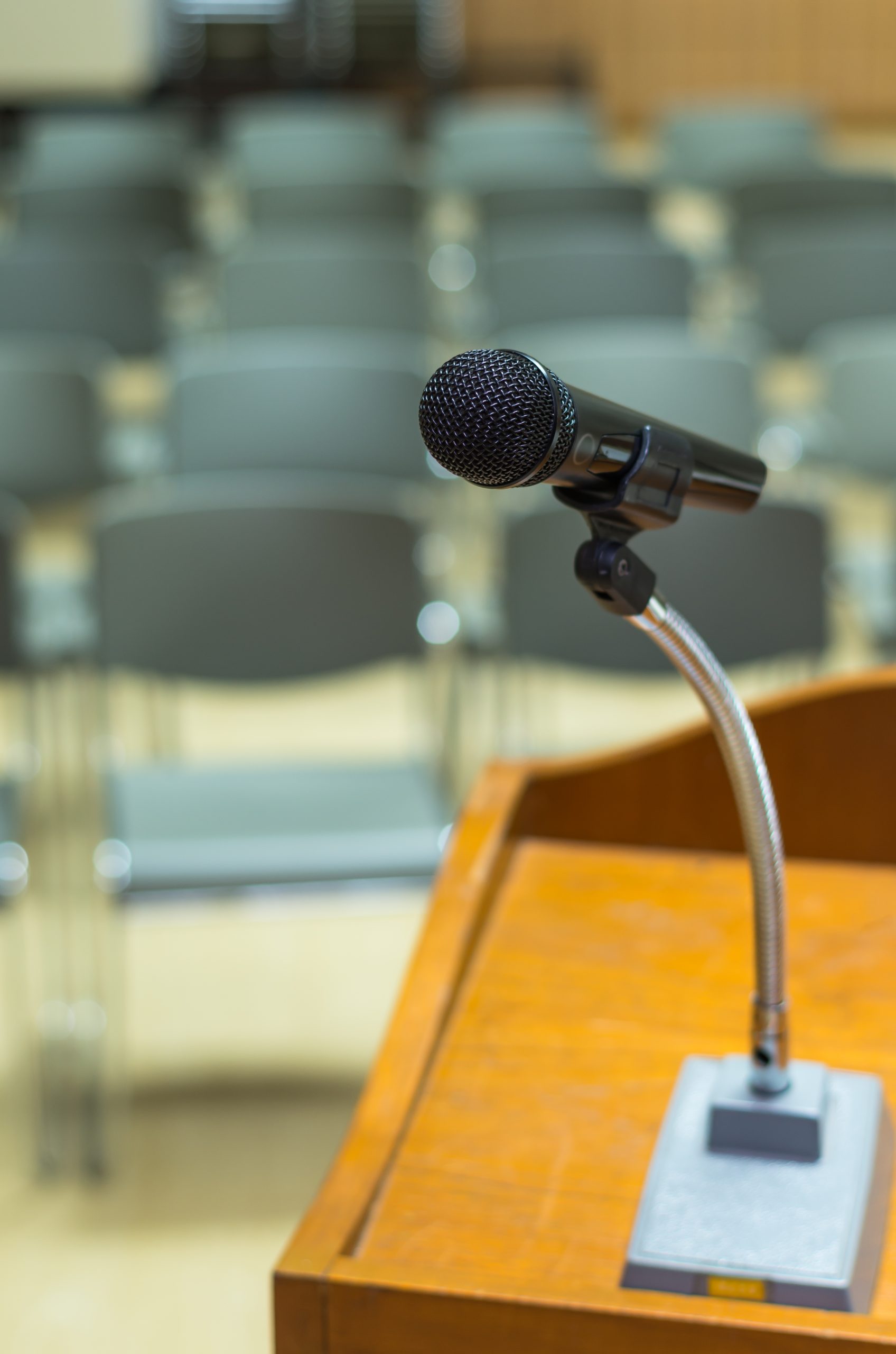 Microphone on the speech podium over the Abstract blurred photo